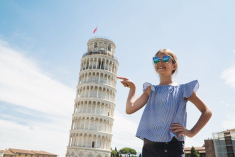 photo of happy child girl pointing leaning tower of pisa.