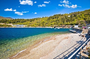 photo of aerial panoramic view of beautiful town of Lovran and sea walkway in Croatia.