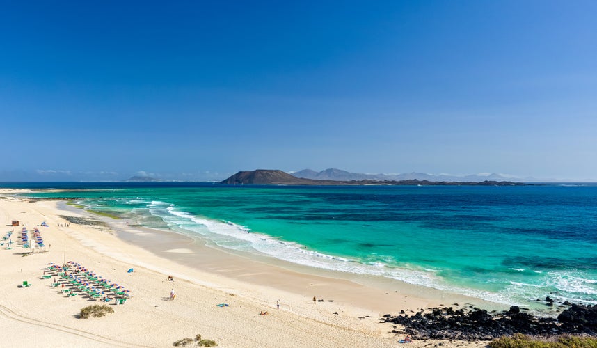 XXL panorama view of the islands of Lobos and Lanzarote seen from Corralejo Beach (Grandes Playas de Corralejo) on Fuerteventura, Canary Islands, Spain, Europe. Beautiful turquoise water & white sand.