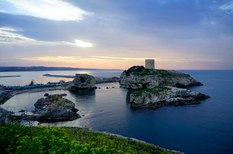 photo of a beautiful sunset landscape of Şile Castle it is a castle on a rock in the sea in Şile, Turkey.
