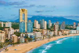 Photo of aerial panoramic view coastline and La Vila Joiosa Villajoyosa touristic resort townscape, sandy beach and Mediterranean seascape, Costa Blanca, Spain.