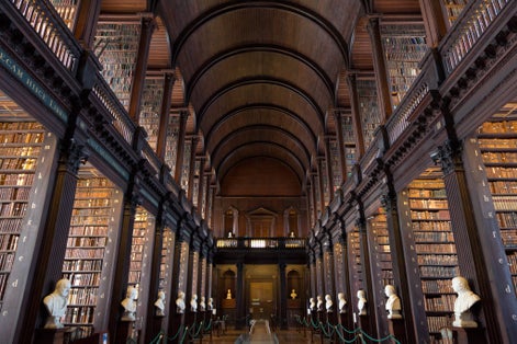 Photo of The Long Room in the Trinity College Library, Dublin, Ireland. Trinity College Library is the largest library in Ireland and home to The Book of Kells.
