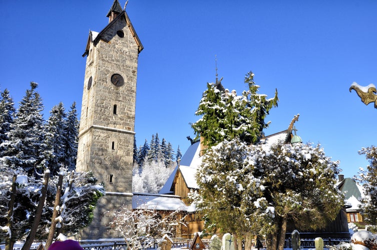 Old wooden Vang stave church with stone tower in Karpacz by winter.