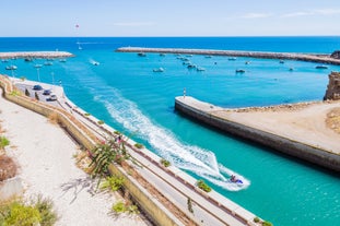 Photo of wide sandy beach in white city of Albufeira, Algarve, Portugal.