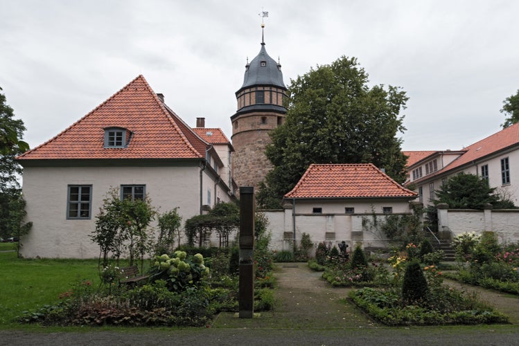 Photo of The Diepholzer castle with tower and roses garden .