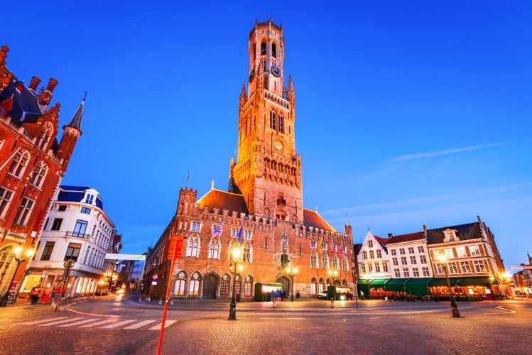 Bruges, Belgium. Blue hour landscape with famous Belfry tower and medieval buildings in Grote Markt, Flanders..jpg