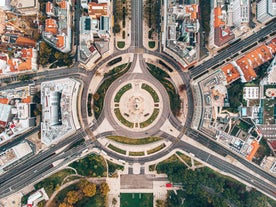 Photo of aerial view over People Crowd Having Fun On Beach And Over Cascais City In Portugal.