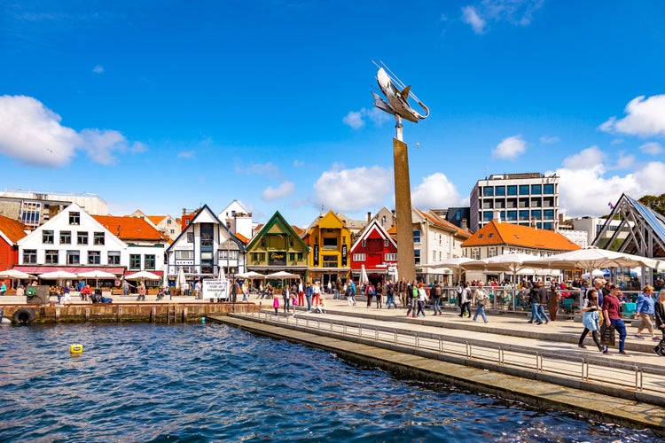 Photo of lots of tourists walking, shopping and sightseeing city center in Stavanger, Norway.