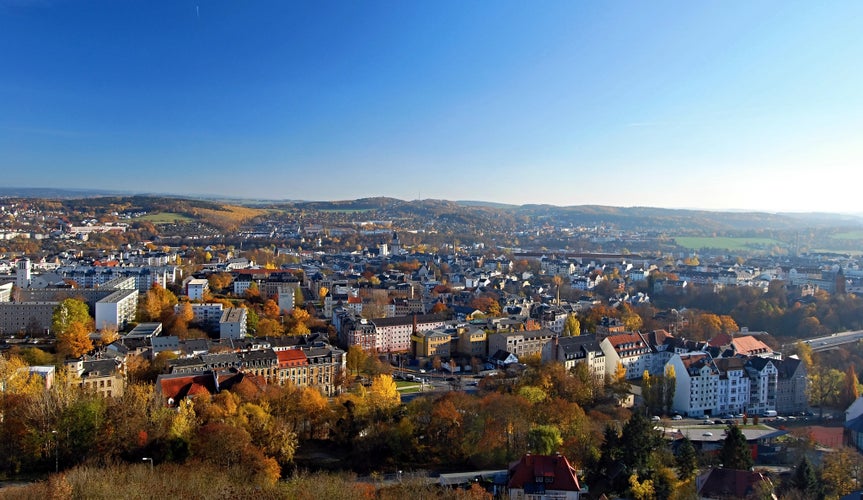 Plauen city with nice landscape with small hills, meadows and colorful forest around from view tower on Barenstein hill in Vogtland region in Saxony (Germany) during nice autumn day with clear sky