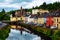 Photo of beautiful landscape in Donegal, Ireland with river and colorful houses.