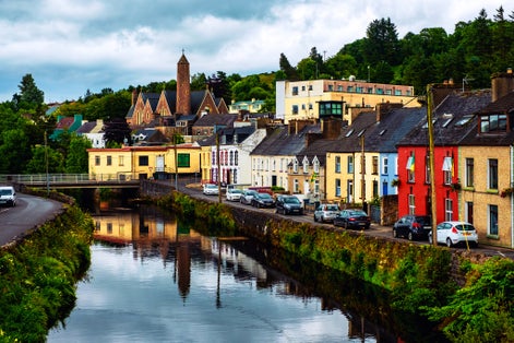 Photo of beautiful landscape in Donegal, Ireland with river and colorful houses.