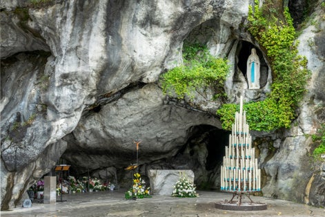 Photo of statue of Virgin Mary in the grotto of Lady of Lourdes, France.