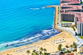 Photo of aerial panoramic view coastline and La Vila Joiosa Villajoyosa touristic resort townscape, sandy beach and Mediterranean seascape, Costa Blanca, Spain.