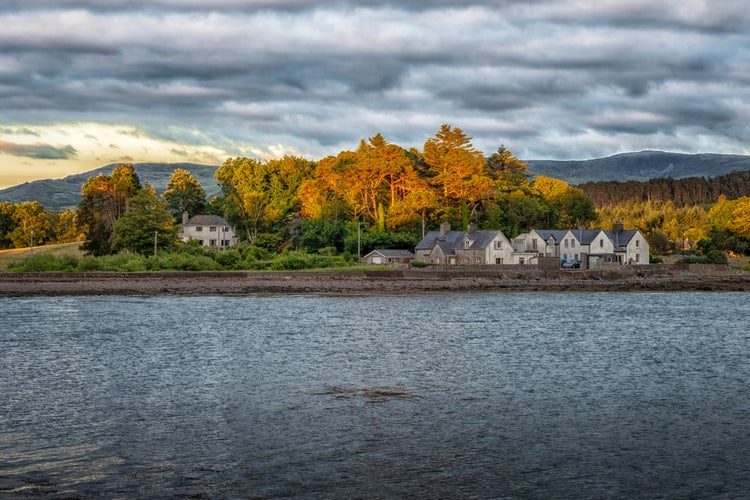 Photo of Kenmare Bay with residential houses in the distant background at Kenmare, County Kerry, Ireland.