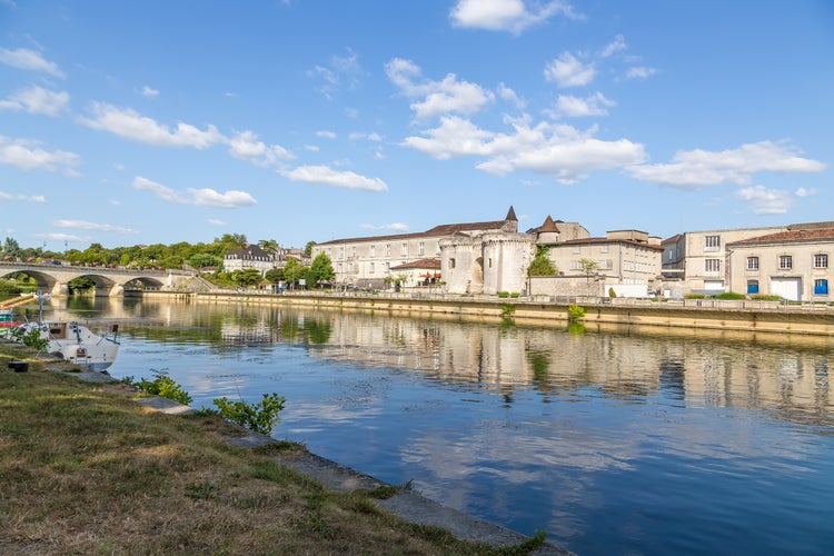 photo of view of Cognac, France. Quay of the Charente river. From left to right: the bridge, the castle of Valois (X - XV centuries.), the city Gate of St. James with towers, 1499, cognac, France.