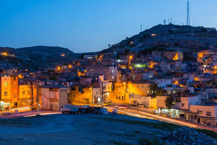 PHOTO OF VIEW OF The night view of the old city seen from the hill of Şanlıurfa, Turkey.