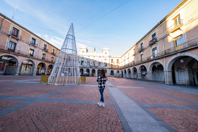 photo of view of Caucasian woman, back view, Avila's winter. Casual elegance, historic charm, exploration delight.