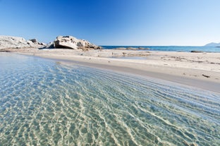 Photo of aerial view of a beautiful bay with azure sea from top of a hill, Villasimius, Sardinia island, Italy.