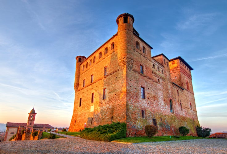 Photo of golden hour view of Grinzane Cavour castle, historical landmark, village in Langhe region, Cuneo, Piedmont, Italy.