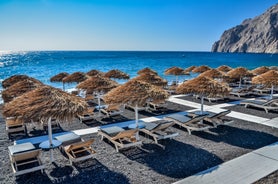 Photo of scenic aerial view of Kamari village and beach at sunrise, Greece.