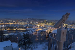 Photo of landscape with mountains, river and buildings in Lillehammer town, Norway.