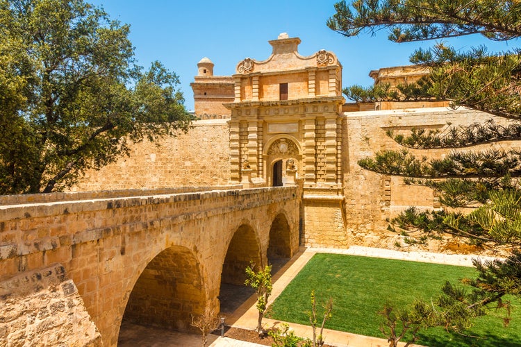 Entrance bridge and gate to Mdina, a fortified medieval city in the Northern Region of Malta.