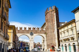 Photo of aerial view of Verona historical city centre, Ponte Pietra bridge across Adige river, Verona Cathedral, Duomo di Verona, red tiled roofs, Veneto Region, Italy.