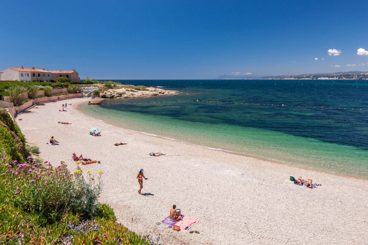 Six-Fours-les-Plages, France - People enjoying the summer in the Coudouliere beach. The area is famous for its landscapes and spots to practice windsurfing and diving.