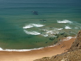 Photo of aerial view of beautiful lighthouse located on high cliffs of Saint Vincent cape in Sagres, Algarve, Portugal.