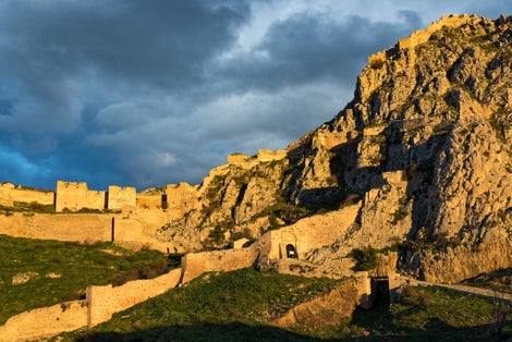 photo of View of the archaeological site of Acrocorinth, the acropolis of ancient Corinth in Peloponnese, Greece at sunset, Corinth. Greece.