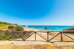 Photo of aerial view of a beautiful bay with azure sea from top of a hill, Villasimius, Sardinia island, Italy.