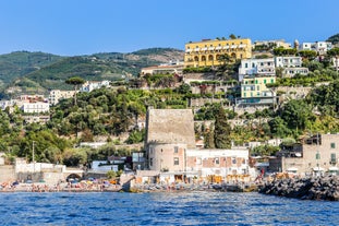 Naples, Italy. View of the Gulf of Naples from the Posillipo hill with Mount Vesuvius far in the background and some pine trees in foreground.