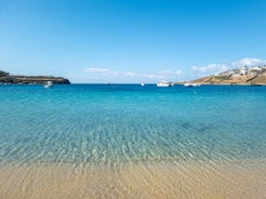 Photo of panoramic aerial view of the popular Platis Gialos beach on the Greek island of Mykonos with turquoise sea, Greece.