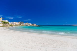 Photo of aerial view of Otranto town in Puglia with crystal turquoise waters, Italy.