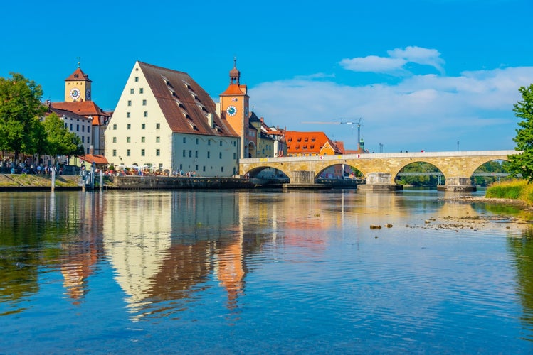 Old stone bridge over river Danube in Regensburg, Germany.