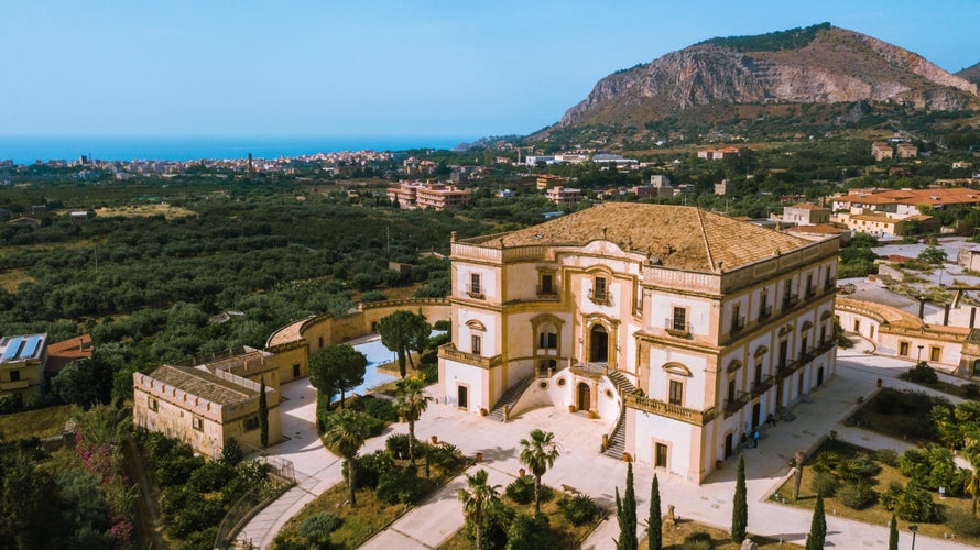 photo of view of Old historical villa in a small Italian town, famous landmark in Sicily, aerial view of a Sicilian town Bagheria with Villa Cattolica, Italy.