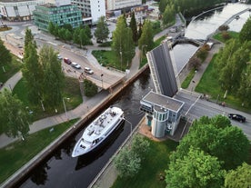 Aerial view of the Tampere city at sunset. Tampella building. View over Tammerkoski river in warm sunlight.