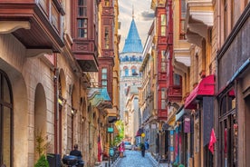 Touristic sightseeing ships in Golden Horn bay of Istanbul and mosque with Sultanahmet district against blue sky and clouds. Istanbul, Turkey during sunny summer day.