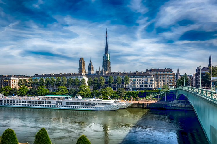 View from the seafront of Saint-Sever, at tView from the seafront of Saint-Sever, at the pier of tourist ships and the Cathedral of Rouen Notre Dame. Rouen, Normandy, France.he pier of tourist ships and the Cathedral of Rouen Notre Dame. Rouen, Normandy, France.