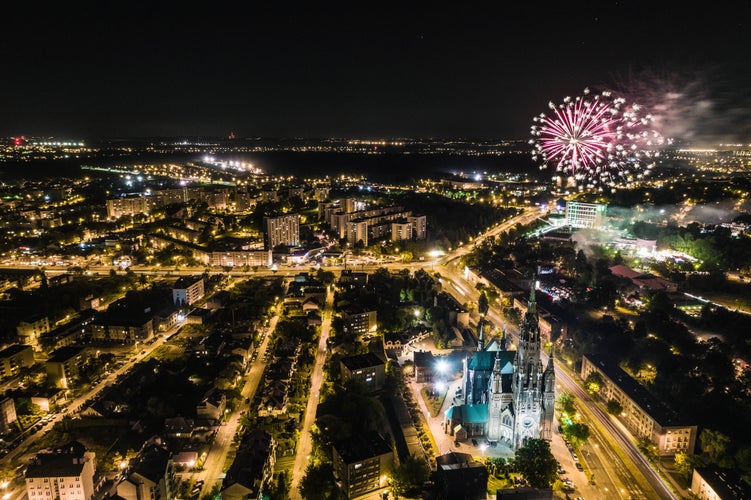 Photo of Many fireworks new year celebration in the city. New year, fete, picnic fireworks show. Dabrowa gornicza, silesia poland aerial drone photo view.