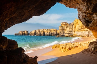 photo of an aerial view of wide sandy beach in touristic resorts of Quarteira and Vilamoura, Algarve, Portugal.