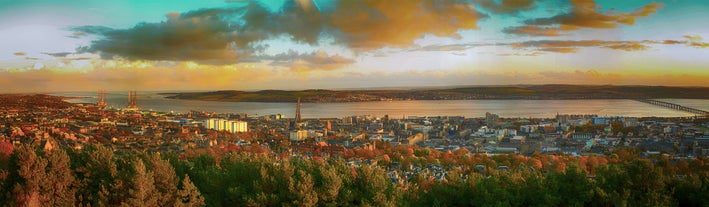 Photo of aerial view of Aberdeen as River Dee flows in a curve to the North Sea showing Duthie Park with bridge and traffic from south.