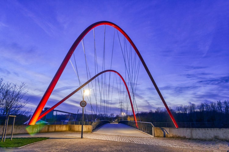 Photo of public park with an illuminated bridge in Gelsenkirchen at night, Germany.