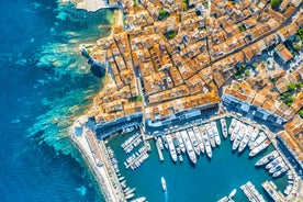 Photo of beautiful aerial view of Saint-Tropez, France with seascape and blue sky.