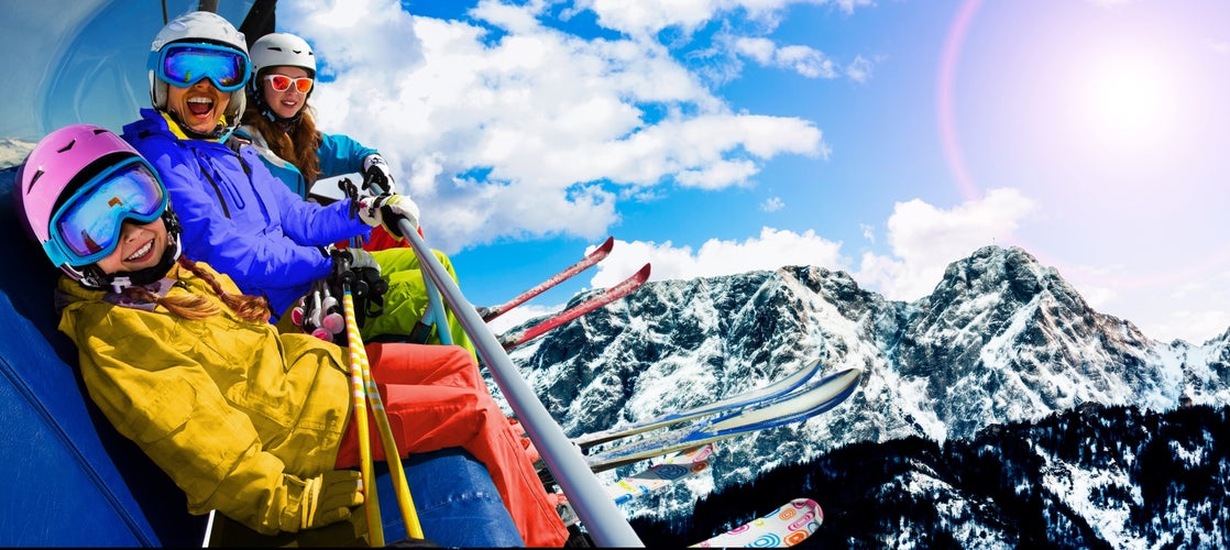 photo of a family skiing in Zakopane, Groomed ski track under Giewont, Tatry, Poland.