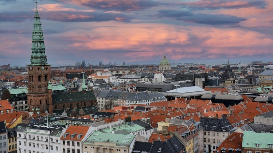 Scenic view of Copenhagen-s rooftops at sunset, featuring the skyline and Frederiks Kirke in the distance..jpg