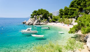 Photo of panorama and landscape of Makarska resort and its harbour with boats and blue sea water, Croatia.