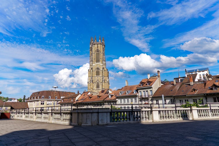 Photo of church tower of St-Nicholas Cathedral at the medieval old town of Swiss City of Fribourg on a sunny spring day, Switzerland.