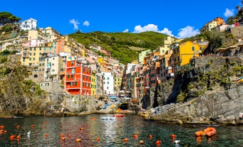 Photo of Riomaggiore with colorful houses along the coastline, one of the five famous coastal village in the Cinque Terre National Park, Liguria, Italy.