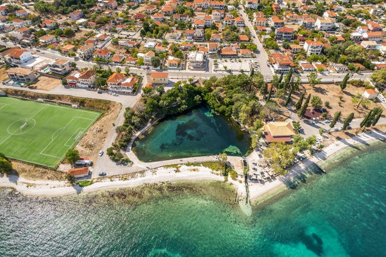 Aerial drone view of Karavomilos lake in Sami town, Kefalonia island, Greece. Ionian sea coast with beautiful beach, turquoise sea water and karst lake Karavomilos with crystal clear water.